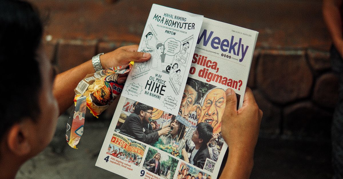 A person reads a weekly newspaper with Filipino headlines on a stone bench.
